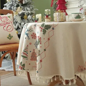 Detail of festive jacquard tablecloth featuring Christmas trees and fringe edges