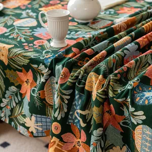 Detailed view of dark green jacquard tablecloth featuring festive floral patterns