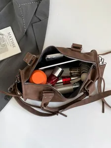 Brown leather Boston tote bag with large capacity interior and adjustable strap