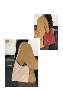 Detail of woven texture hobo bag showing fine craftsmanship and metal strap connectors