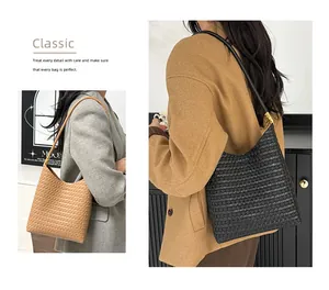 Detail of woven texture on hobo shoulder bags in classic black and light brown colors