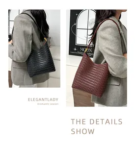 Detail showing woven texture and gold hardware on black and brown tote bags