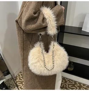 Detail shot of the plush faux fur texture and silver bead chain handle on the beige bag