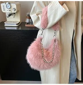 Detailed side view of a pink plush crescent bag with pearl chain and furry strap