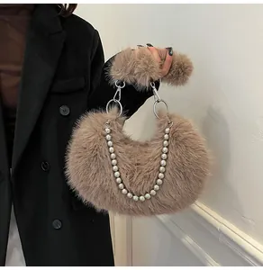 Detailed view of khaki faux fur crescent bag featuring elegant pearl chain and plush handle