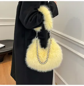 Detail of light yellow faux fur shoulder bag with decorative silver beaded chain