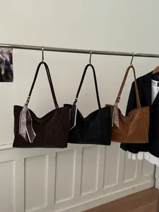 Detailed display of large capacity tote bags in coffee black and caramel with silk scarves