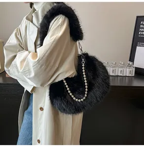 Detail of black faux fur crescent bag with pearl chain and matching plush shoulder strap