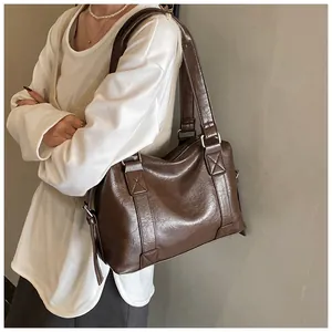 Detail of vintage dark brown tote bag with oily leather finish and silver hardware