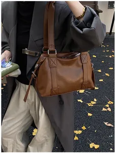 Close-up of a brown vintage leather shoulder bag textured detail with a fall fashion vibe