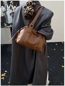 Brown faux leather shoulder bag with double straps and side tassel detail