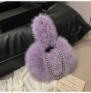 Detail of purple faux fur handbag featuring elegant silver beaded chain strap and soft texture