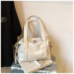Detail view of cream white PU leather hobo bag showing texture and reinforced handles