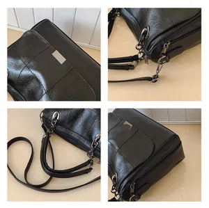 Detail of black faux leather Boston bag featuring stitching and gunmetal hardware
