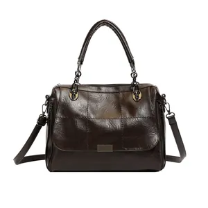 Retro dark brown Boston bag with oil-wax texture and adjustable shoulder strap