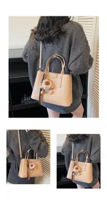 Detail of apricot lychee pattern bag with lion plush charm and printed silk scarf