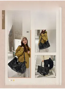 Detail view of large black shiny PU leather travel bag with side zipper pocket