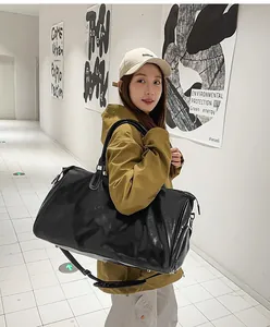 Detail of waterproof black PU leather travel bag with large capacity and shoulder strap