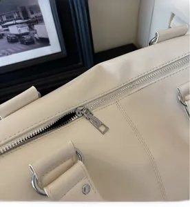 Detailed macro view of smooth silver zipper and stitching on the beige tote bag