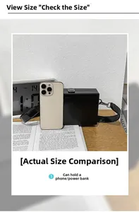 Detailed size comparison of black faux leather box bag next to a smartphone