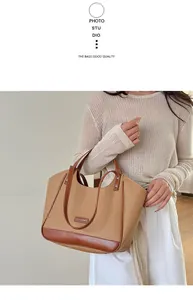 Détail d'un grand sac cabas en cuir PU marron avec coutures contrastées et écusson mode