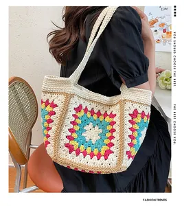 Detailed back view of a handmade crochet tote bag with colorful floral knit patterns