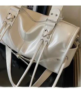 Close-up of cream PU leather tote showing side lace-up detail and silver metal eyelets