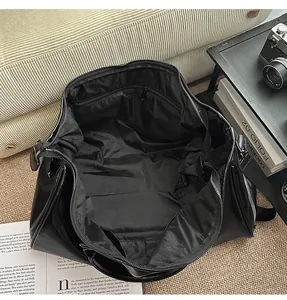 Interior view of large capacity black PU travel bag showing zipper pocket and lining