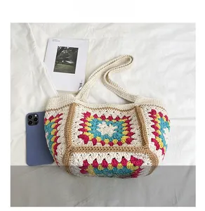 Detail view of colorful crochet tote bag with phone and magazine for size comparison