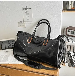 Close-up of a large black waterproof PU leather travel bag with brown leather details