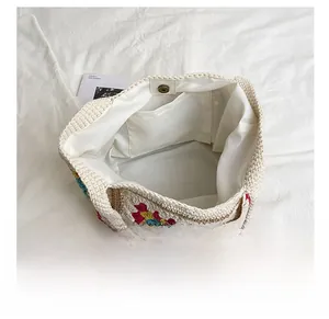 Detail view of woven bucket bag with interior pocket, magnetic closure and colorful pattern