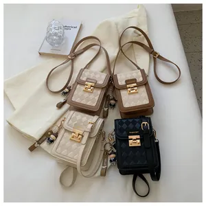 Close-up of quilted crossbody phone bags in four colors with bear charms and metal locks