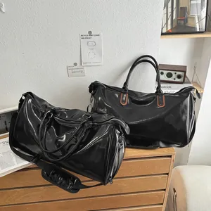 Large vintage black PU leather travel duffel bag with reinforced handles and shoulder strap