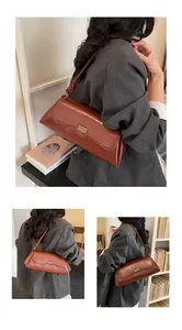 Dettaglio della borsa baguette vintage marrone con elegante fibbia in metallo dorato