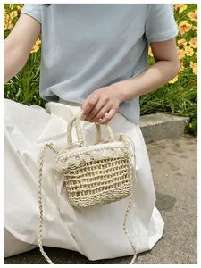 Detail of straw woven bucket bag featuring lace ruffles, pearls and drawstring liner