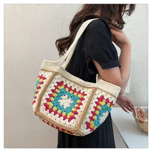 Detailed close-up of handmade crochet tote bag with colorful granny square patterns