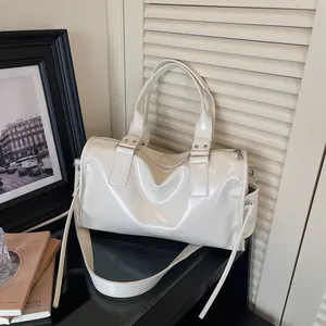 Glossy cream white cylinder tote bag with dual handles and shoulder strap for daily commuting