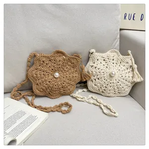 Handwoven boho straw crossbody bags with pearl center and tassel charms in neutral tones