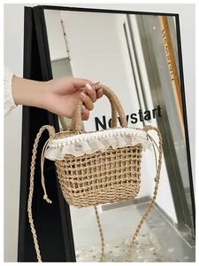 Detail of woven straw bag with delicate lace trim, pearl accents, and a drawstring closure