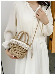 Detail of straw bucket bag with white lace ruffles and double row pearl trim decoration