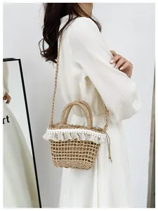 Straw bucket bag with white lace ruffles, pearls, and drawstring closure detail