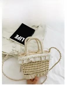 Detailed close-up of woven straw bucket bag featuring lace edges and pearl bead accents