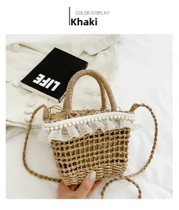 Close-up of khaki woven straw bag with elegant white lace and pearl accents