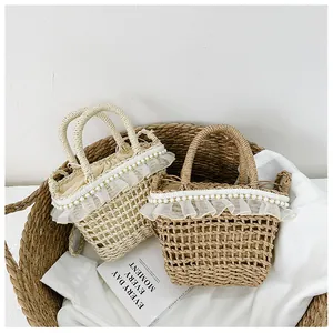 Detail of straw woven bags with delicate lace ruffles and pearl accents in a basket