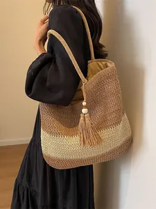 Woven straw tote bag with gradient brown stripes, fringe tassel and shoulder strap