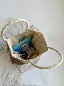 Two-tone woven straw tote bag with round handles and spacious interior compartments