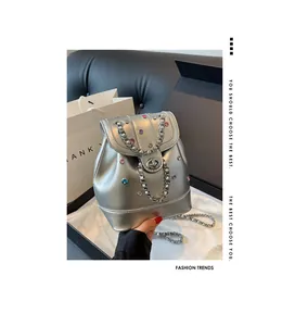 Detailed shot of silver Y2K backpack with colorful rhinestones and metal chain decor