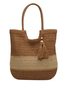 Two-tone woven straw tote bag with round handles and tassel pendant detail