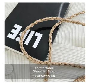 Detail shot of the durable hand-woven shoulder strap on a natural straw bucket bag