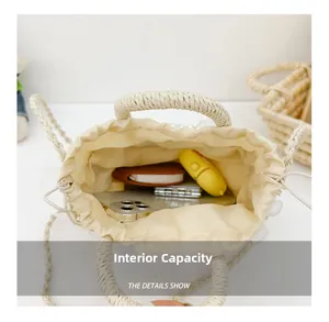 Overhead view showing internal capacity of woven straw bucket bag with drawstring lining